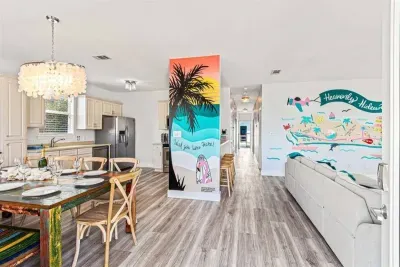 Walking into this space feels open and cheerful, with the dining area, kitchen, and living room flowing together so everyone stays connected.