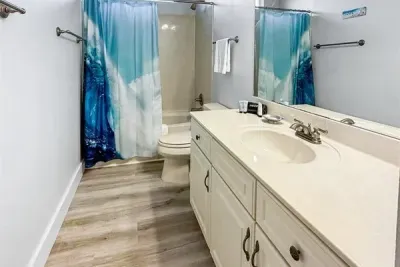 A clean, easy to use bathroom with a full tub and shower, fresh towels, and everything you need to feel comfortable and refreshed.