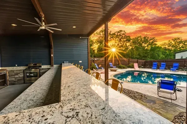 Covered Outdoor Bar and Entertainment Area Overlooking the Pool