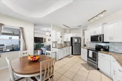 Bright and spacious kitchen with ample counter space, white cabinetry, and an open layout that makes cooking and gathering easy.