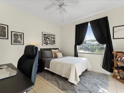 Guest bedroom with dedicated workspace desk, comfortable full sized bed, ideal for work or relaxation.