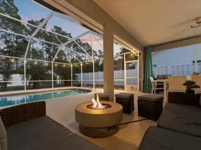 Covered outdoor patio with seating and pool views, ideal for enjoying Florida evenings year round.