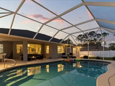 Private screened pool glowing at night, perfect for peaceful evenings and late night relaxation.