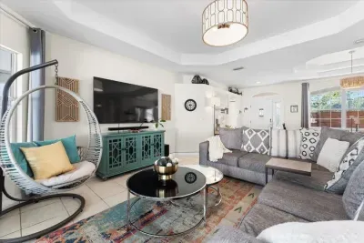 Bright and inviting living room with comfortable seating, large smart TV, and an open layout perfect for gathering together.