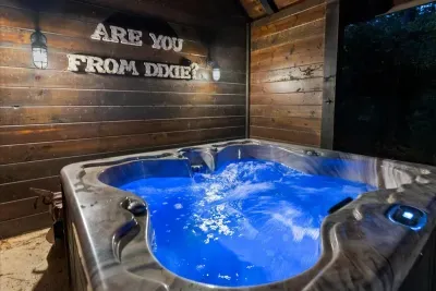Private hot tub glowing under the cabin lights for the ultimate evening soak.