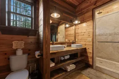Charming bathroom with a farmhouse sink, wooden accents, and soft natural light.