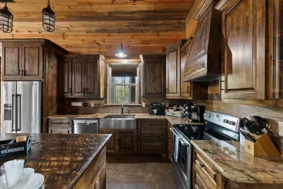 Modern kitchen featuring stainless steel appliances, granite counters, and wood cabinetry.