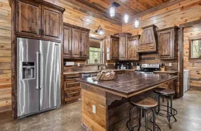 Fully equipped kitchen with stainless steel appliances and a farmhouse-style island.