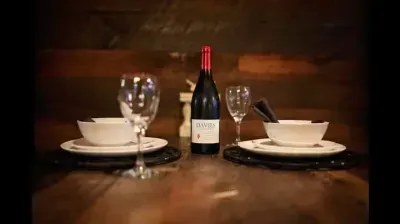 Wine and plates on rustic table perfect for ramantic dinners