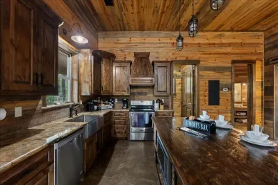 Modern kitchen with stainless steel appliances and warm wood finishes.
