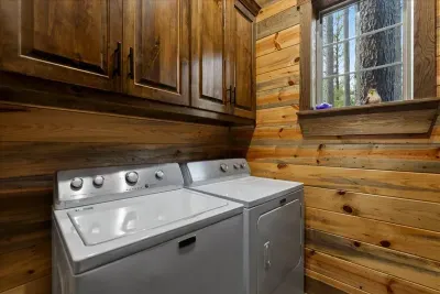 Convenient laundry room with modern washer and dryer to keep clothes fresh during your stay.