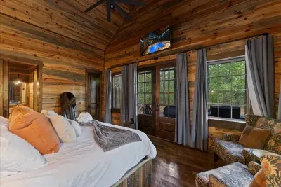 Peaceful bedroom escape surrounded by nature and warm cabin charm.