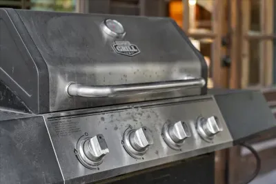 Premium outdoor grill ready for family barbecues and alfresco dining under the trees.