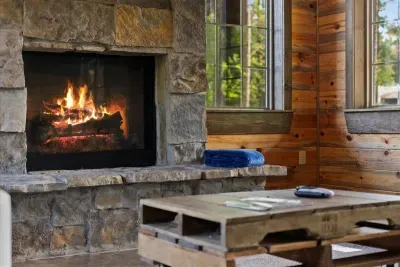 Cozy stone fireplace surrounded by natural wood tones-perfect for fireside relaxation.