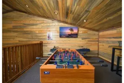 This loft game space is perfect for downtime, with a foosball table and cozy setup that makes it easy to relax and have fun