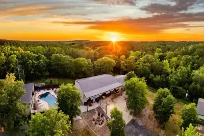 Aerial views show the beauty of the property, with open land, a private pool, and a true countryside retreat feel