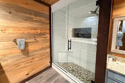 A spacious walk in shower with clean finishes that make getting ready feel simple and relaxed