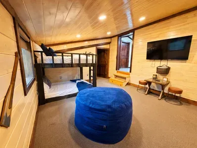 This bunk room adds a relaxed hangout vibe, with extra seating and space to unwind after a day outdoors