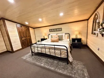 Primary King bedroom with soft lighting, comfortable bedding, and a calm atmosphere that makes rest come easy