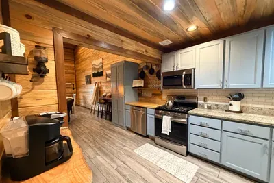 Another view of the kitchen where the warm wood tones and open layout make every meal feel comfortable and unhurried