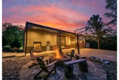 The outdoor area comes alive in the evening, with firelight, open space, and a peaceful farm stay atmosphere