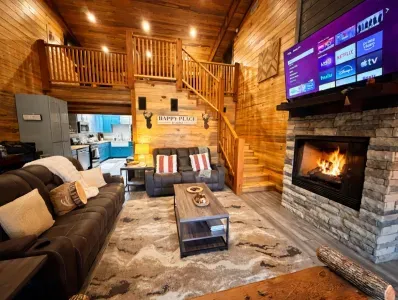 This living room feels warm and inviting with a fireplace, plush seating, and a layout designed for gathering and unwinding