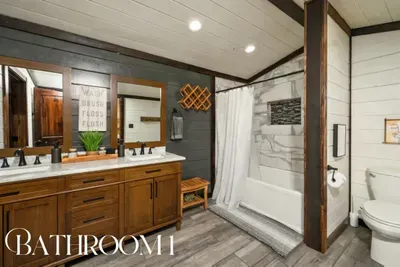 A spacious bathroom with double vanity and a full tub and shower, making it easy for everyone to get ready comfortably