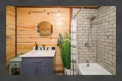 A charming bathroom with rustic touches, a walk in shower, and thoughtful details that fit the cabin feel
