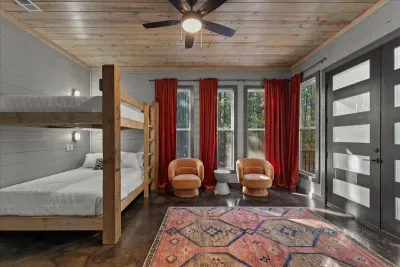 Inviting lounge space with warm textures and forest-facing windows for ultimate relaxation