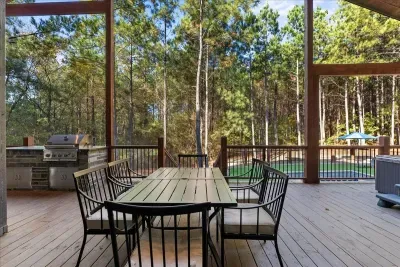 Outdoor dining area with a large dining table and views of the pines