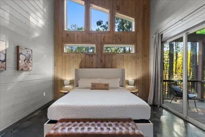 Bedroom Retreat: Dream in style with a king bed, sleek decor, and nature's view at your doorstep!