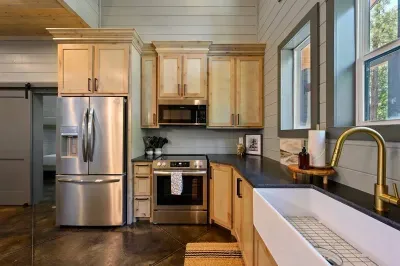Kitchen: Sleek stainless appliances and farmhouse sink invite culinary adventures in style!