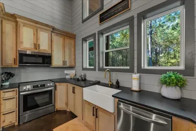 Bright and modern kitchen framed by natural light and scenic outdoor views
