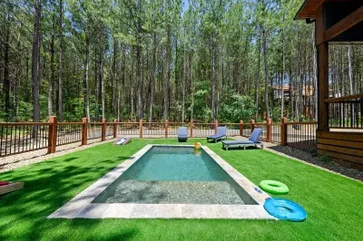 Private pool with lounge chairs and forest views