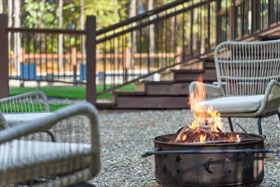 Fire pit area with comfortable chairs for enjoying warm evenings and quiet time under the trees.