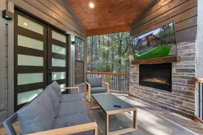 Covered outdoor seating area with fireplace and comfortable lounge furniture