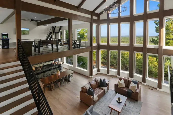 Breathtaking high-angle perspective showcasing the majestic open-concept living room and soaring ceilings.