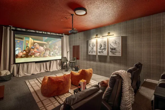Enjoy cinematic evenings in your private home theater, featuring plush seating and a 120-inch screen for an elevated movie experience.