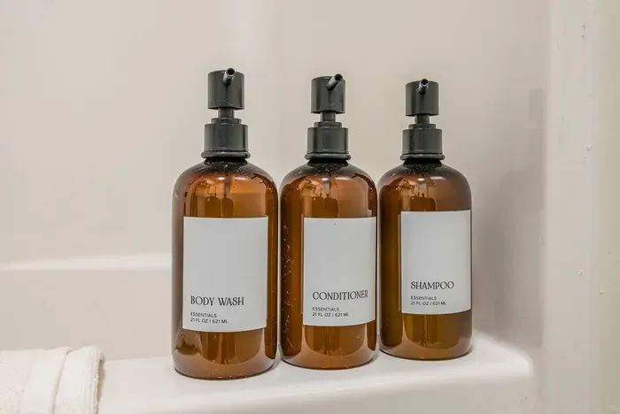 Spa-inspired essentials — shampoo, conditioner, and body wash in a calming Green Tea Lemongrass scent, ready for your stay.