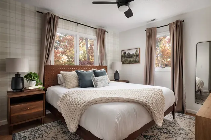 Settle into a warm and inviting retreat—complete with a plush king bed, charming plaid wallpaper, a full dresser, and a 50” Roku TV for unwinding in style.