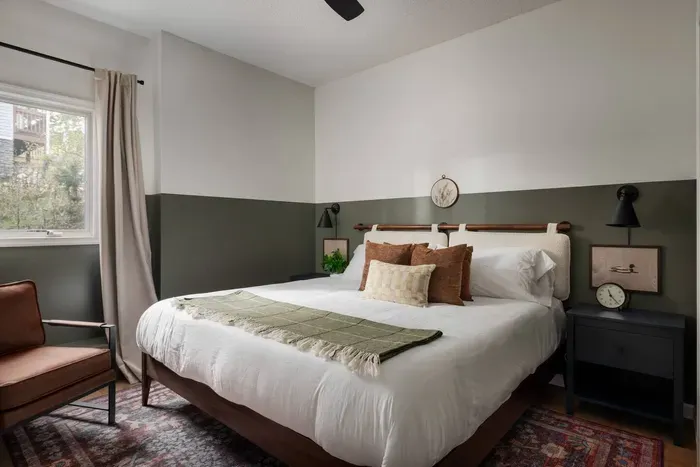 Relax in this serene king bedroom, featuring a 50” Roku TV and a cozy lounge chair for unwinding in comfort.
