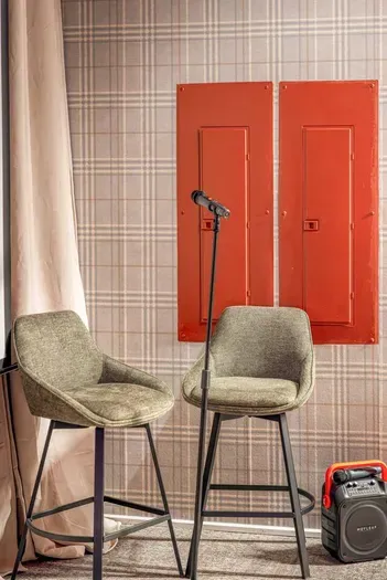 Gather for impromptu karaoke nights in this cozy lounge, complete with plush seating and your own stage-ready spotlight.