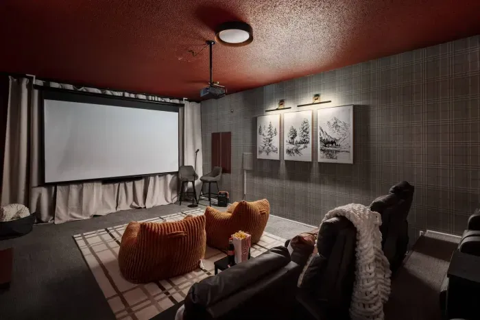 Enjoy cinematic evenings in your private home theater, featuring plush seating and a 120-inch screen for an elevated movie experience.
