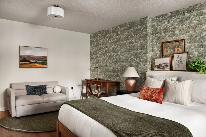 A comfy pullout sofa doubles as extra sleep space and a cozy lounge area, complete with a convenient desk workspace.