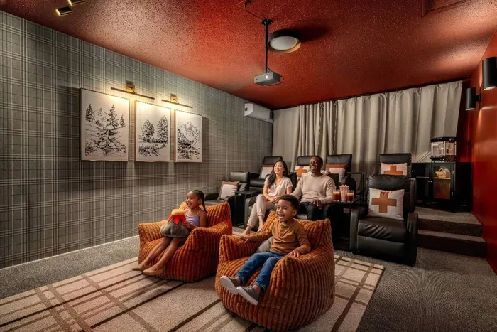 Private theater room with plush lounge seating.