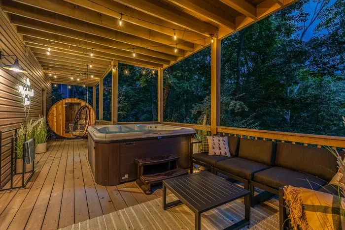 After a soothing soak in the hot tub, unwind in the lounge seating or step into the cedar sauna — a peaceful forest retreat made for relaxation.