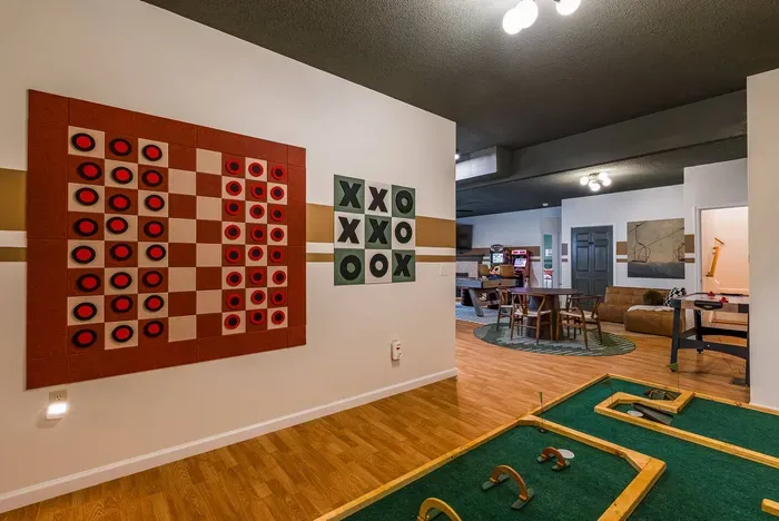 Enjoy life-sized checkers, tic-tac-toe, and indoor mini golf — playful touches that make the space fun for all ages.