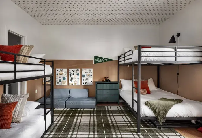 The ultimate kids’ bunk room! Two sturdy bunk beds (twin and full sized—including a toddler-friendly twin floor bed), plus a cozy lounge space and playful decor. Perfect for sleepovers and fun.