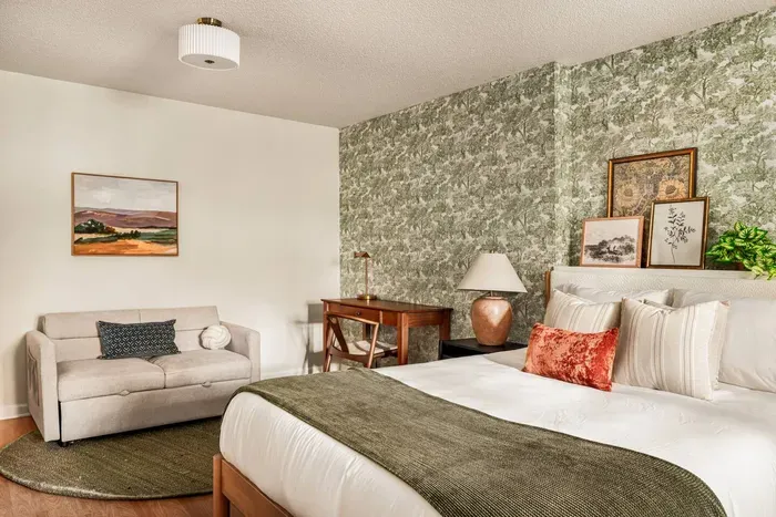 A comfy pullout sofa doubles as extra sleep space and a cozy lounge area, complete with a convenient desk workspace.