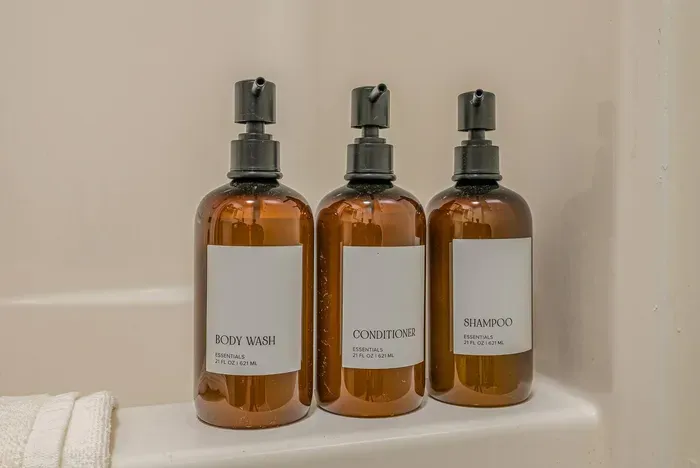 Spa-inspired essentials — shampoo, conditioner, and body wash in a calming Green Tea Lemongrass scent, ready for your stay.